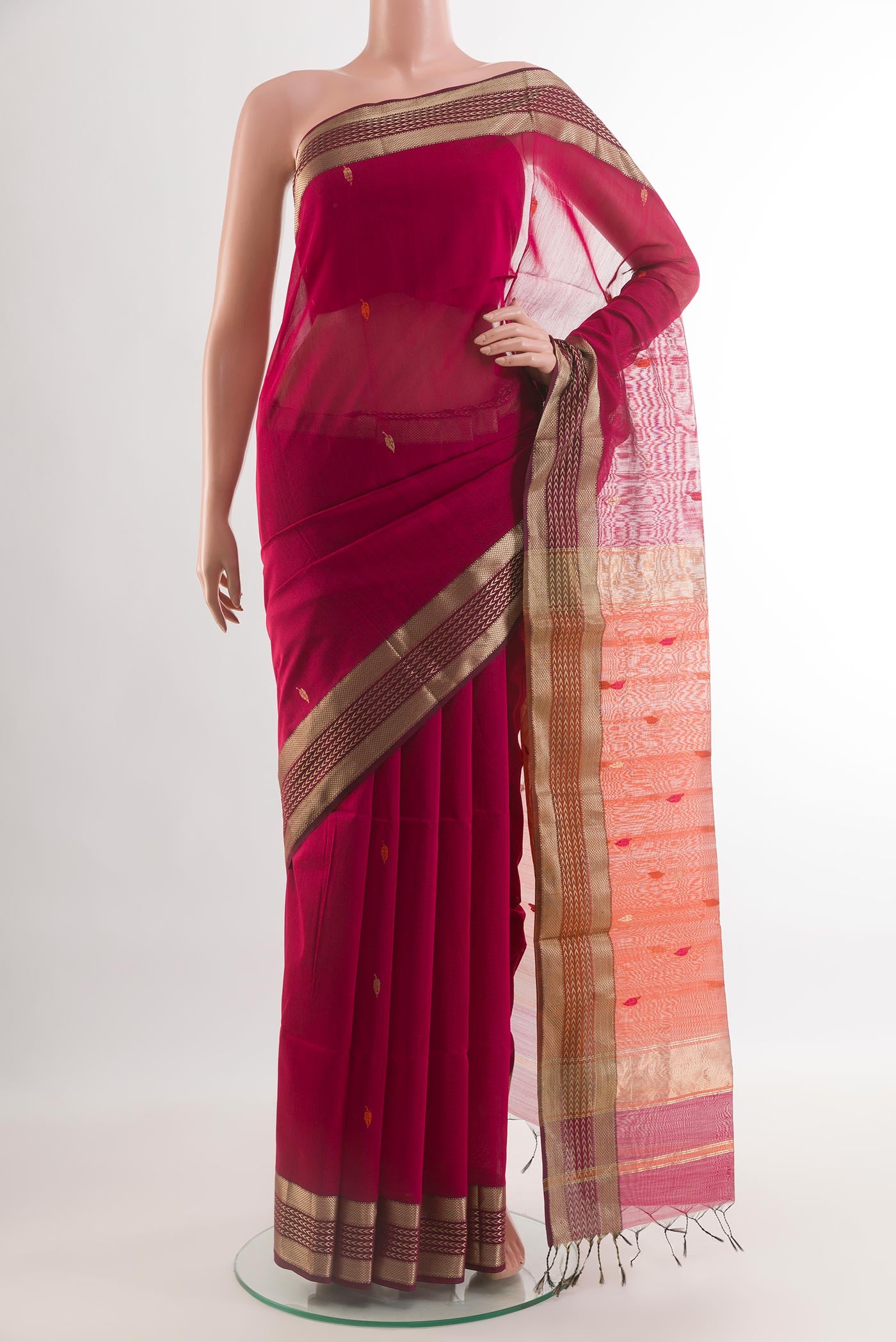 Pink Maheshwari Silk Cotton Saree with Thread Butta on the body and Zari Border.  displayed on a mannequin