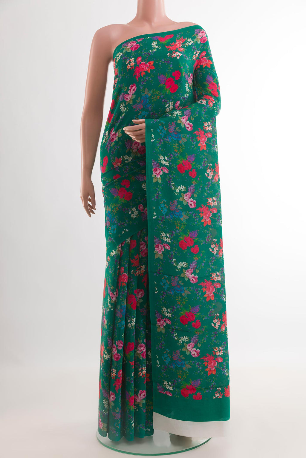 Green Crepe Saree with Printed design on the body and Plain Border.  displayed on a mannequin