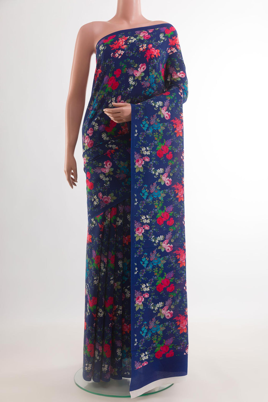 Blue Crepe Saree with Printed design on the body and Plain Border.  displayed on a mannequin