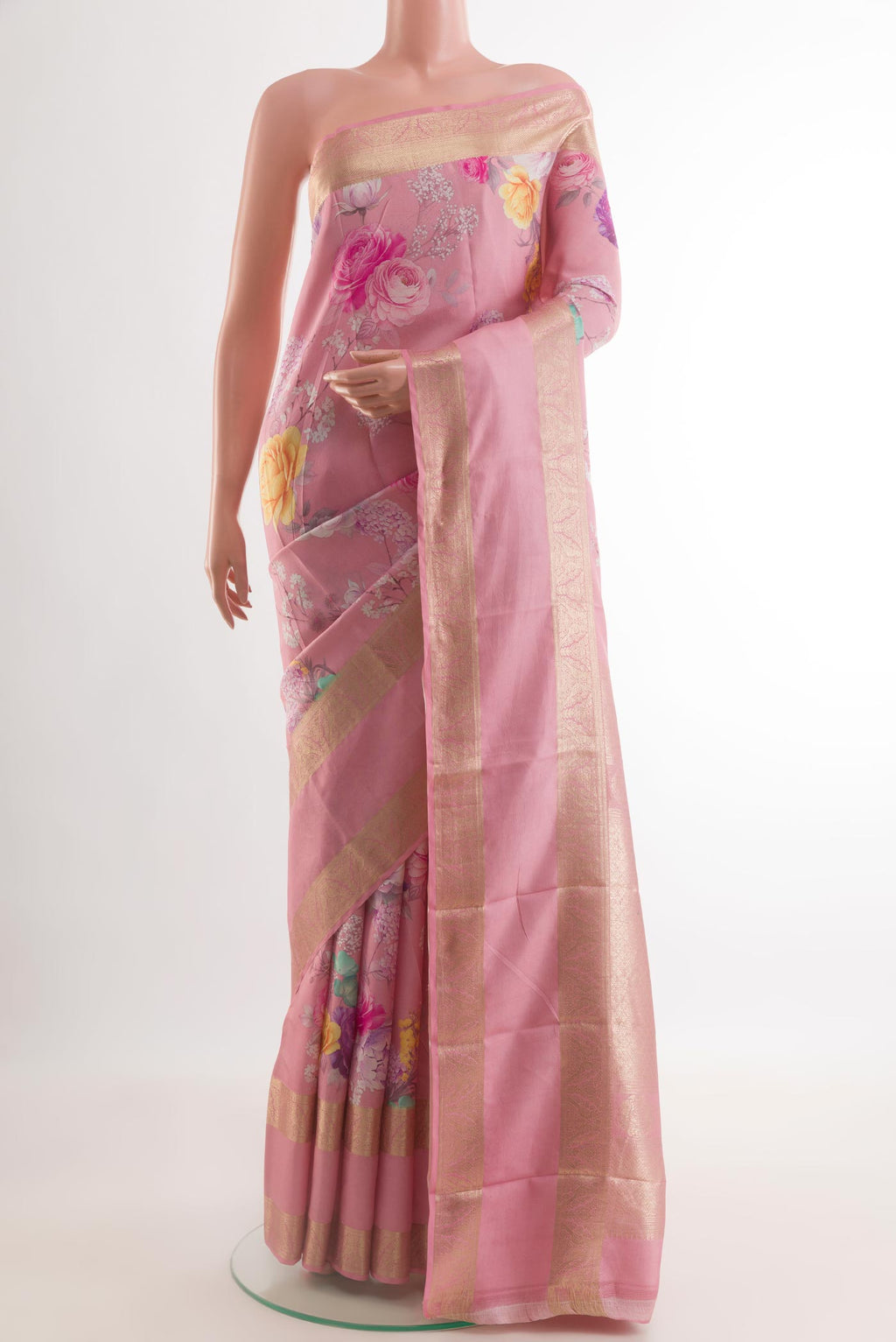 Pink Printed Silk Saree with Floral Print on the body and Zari Border.  displayed on a mannequin