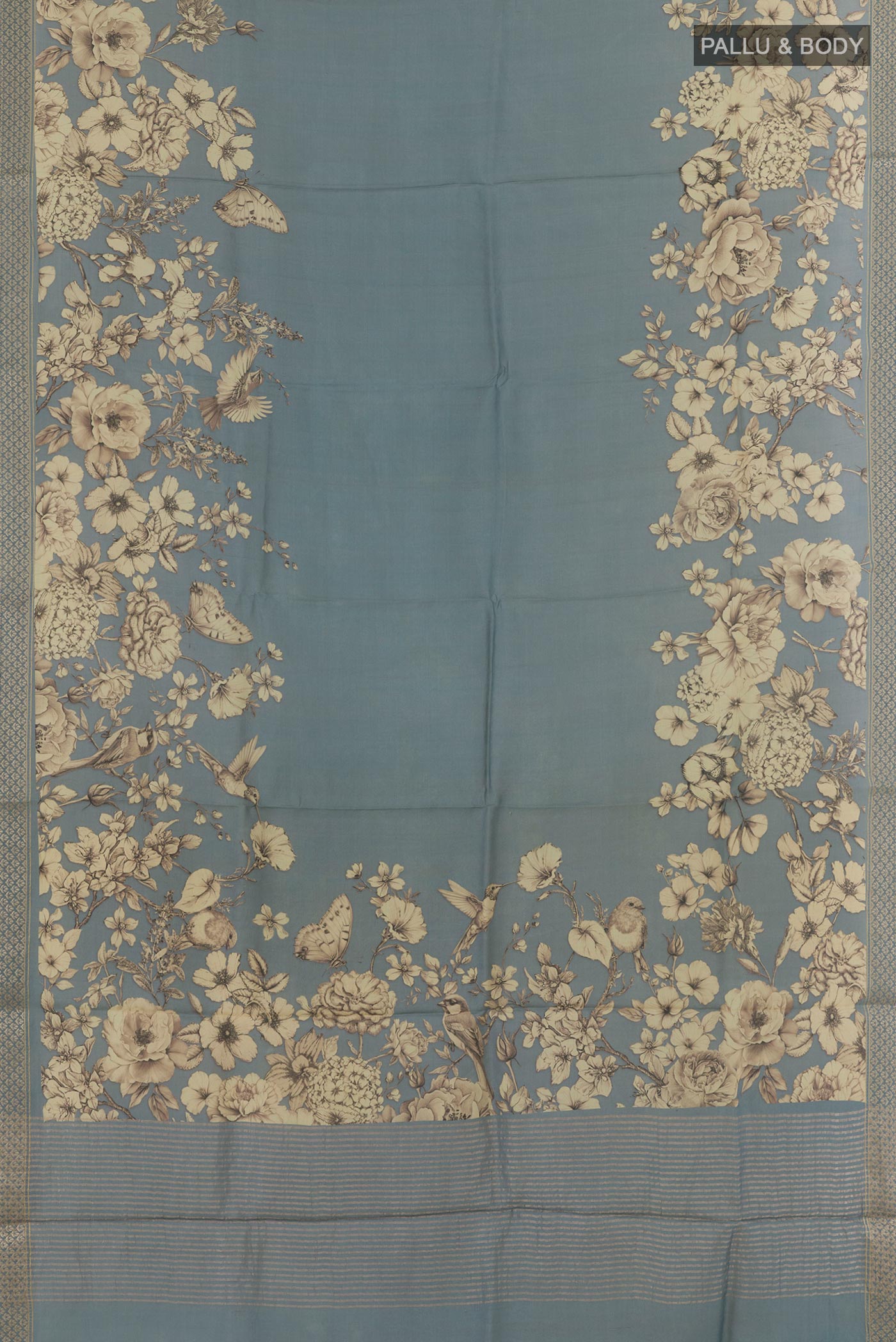 Flat view of Grey Tussar Silk Saree with Printed design on the body and Zari Border. 