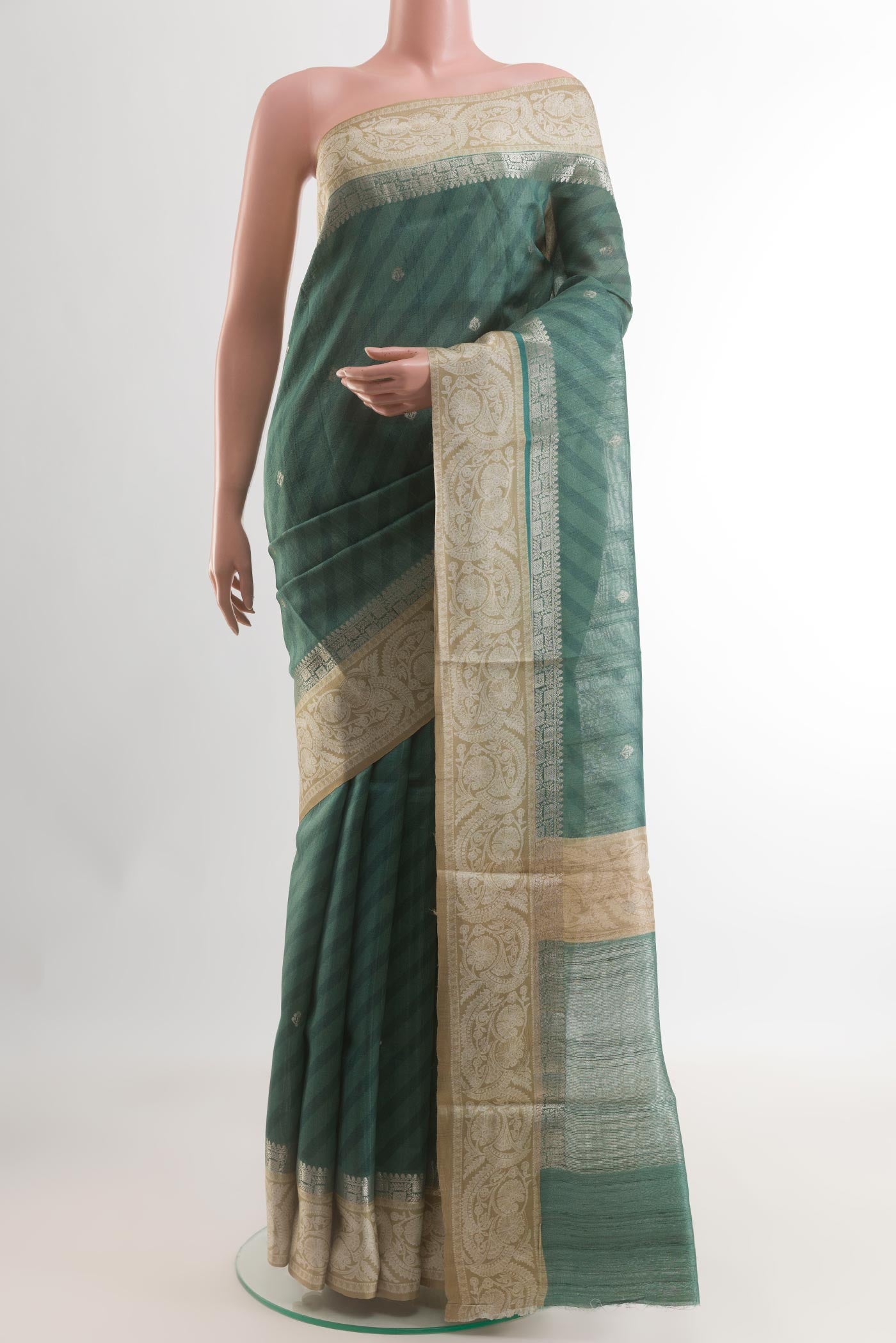 Green Tussar Saree with Zari Butta on the body and Zari Border.  displayed on a mannequin
