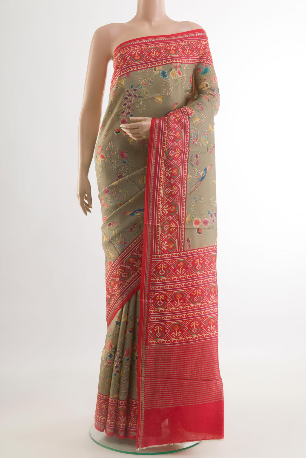 Beige Tussar Silk Saree with Printed design on the body and Zari Border.  displayed on a mannequin