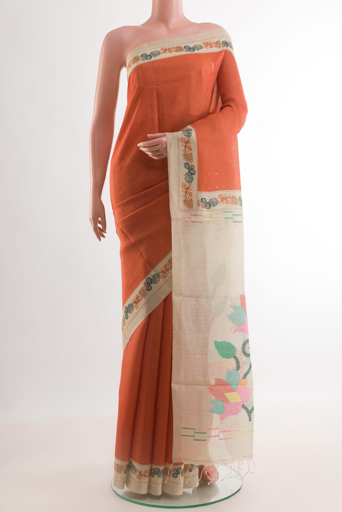 Rust Tussar Silk Saree with Abstract Print on the body and Printed Border.  displayed on a mannequin
