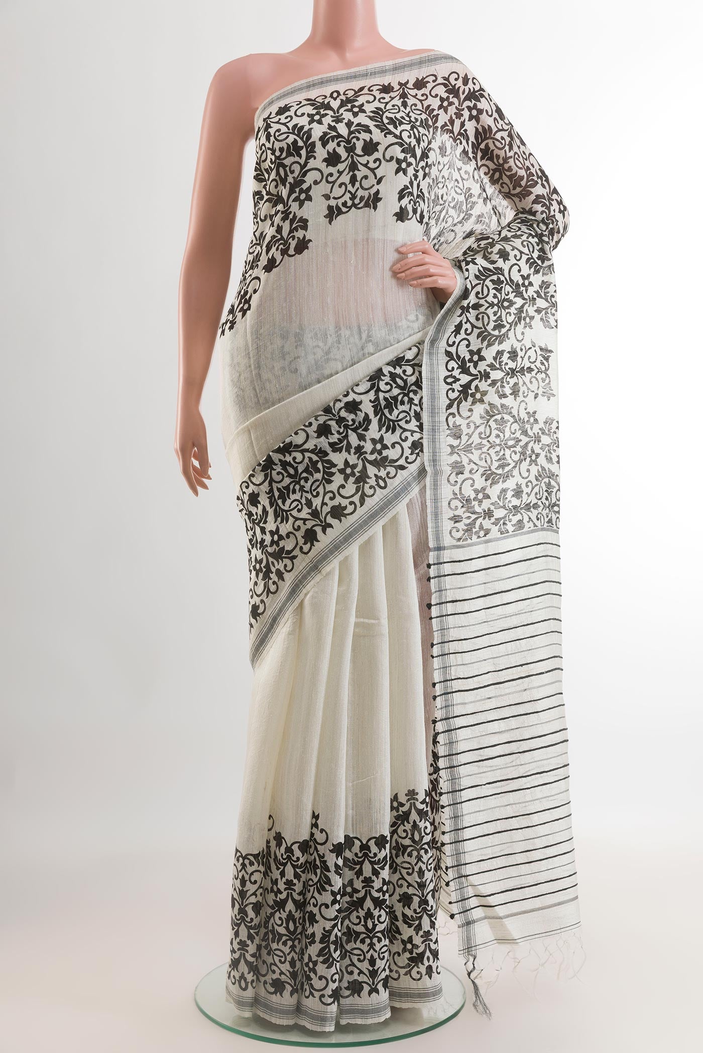 White Tussar Silk Saree with Plain Body and Printed Border.  displayed on a mannequin