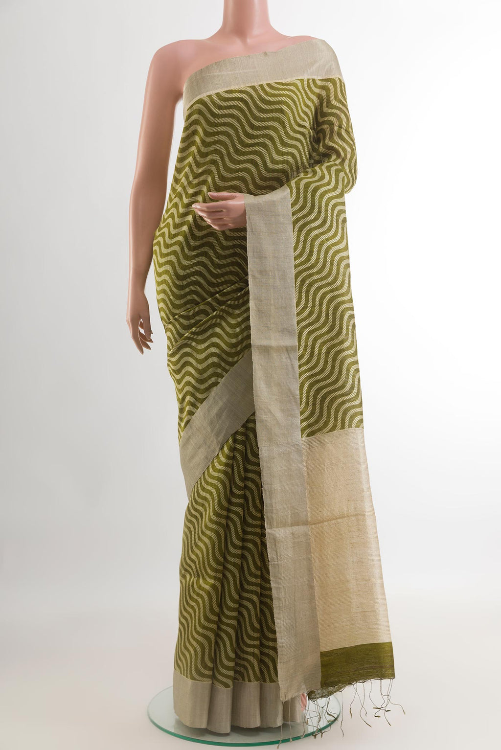 Green Tussar Silk Saree with Printed design on the body and Zari Border.  displayed on a mannequin