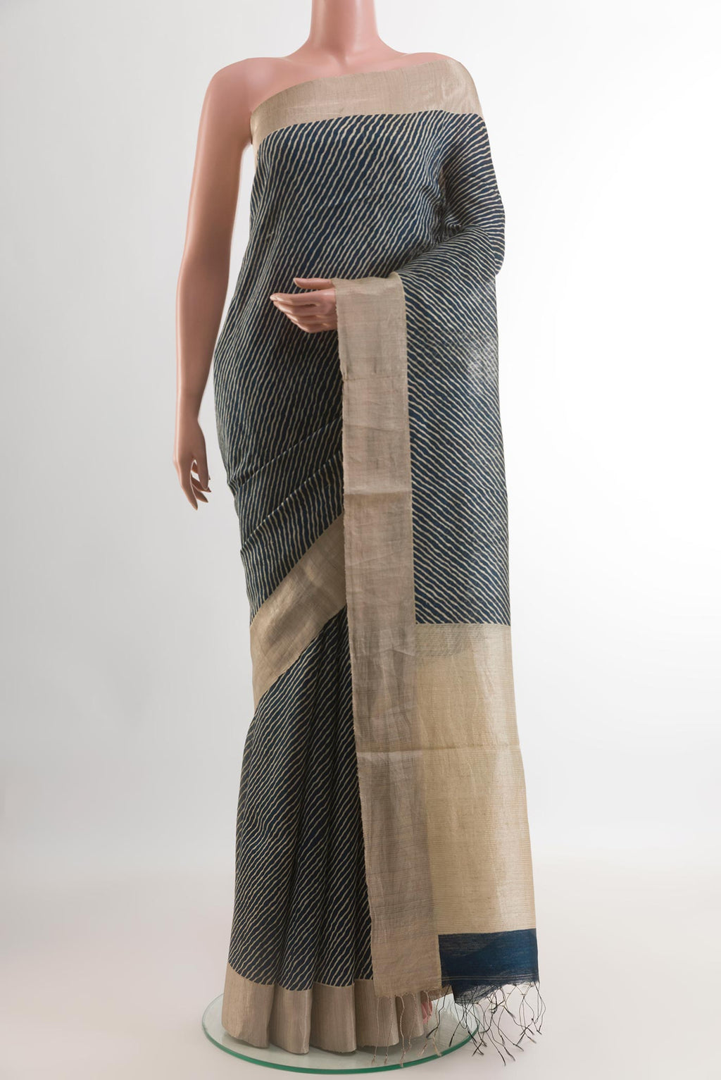 Blue Tussar Silk Saree with Printed design on the body and Zari Border.  displayed on a mannequin