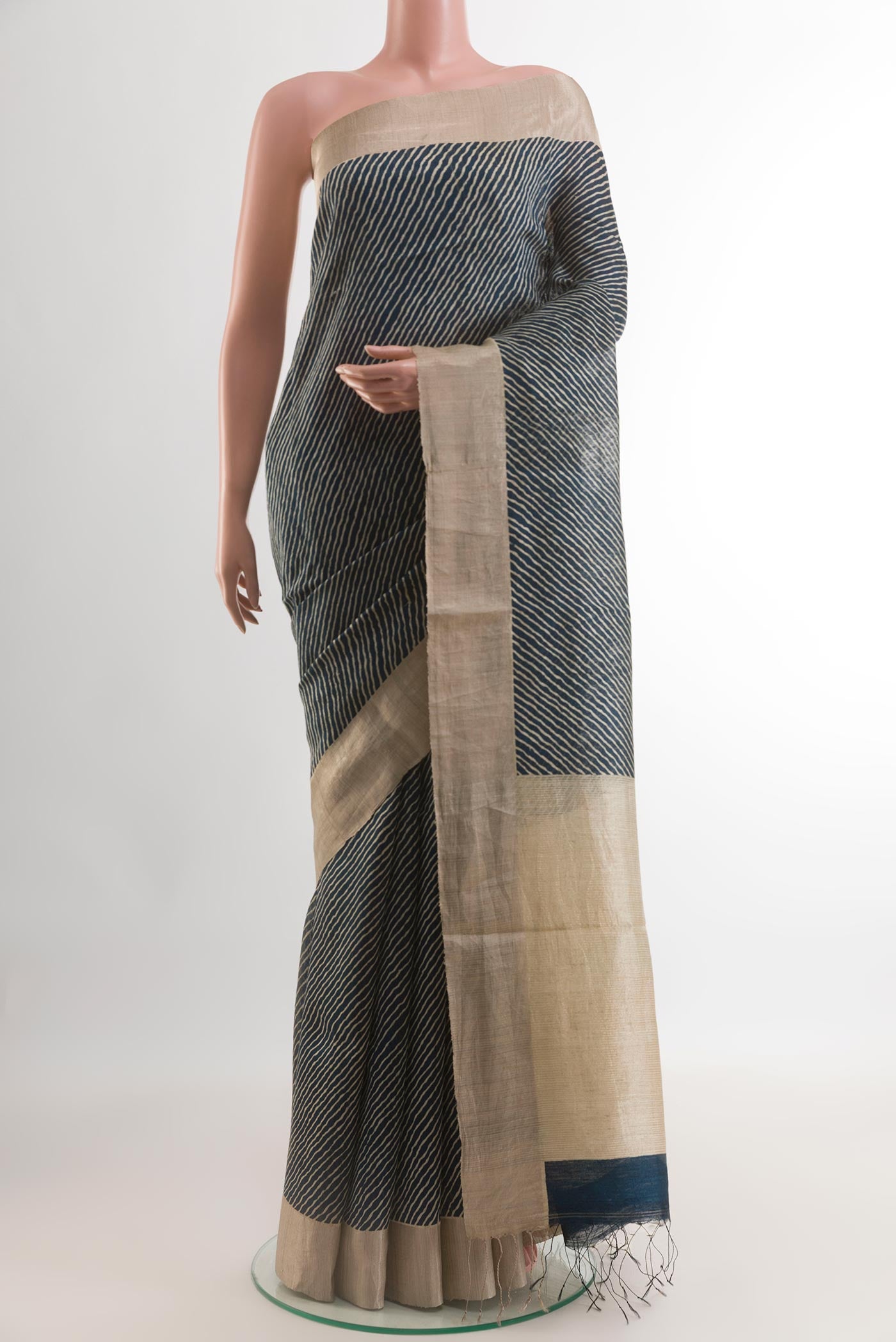 Blue Tussar Silk Saree with Printed design on the body and Zari Border.  displayed on a mannequin