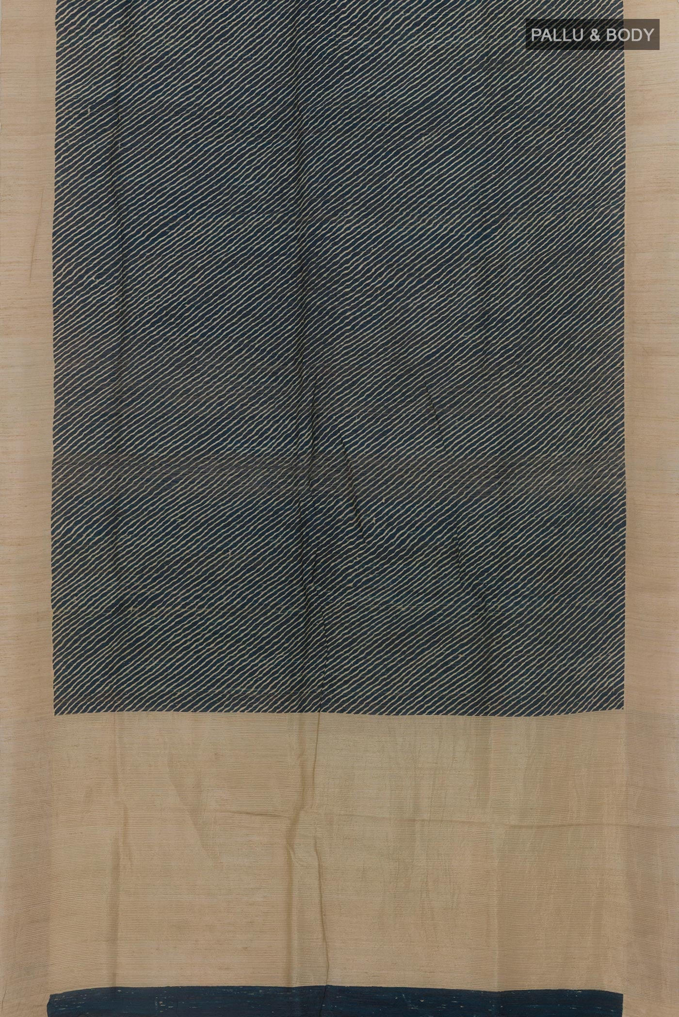 Flat view of Blue Tussar Silk Saree with Printed design on the body and Zari Border. 