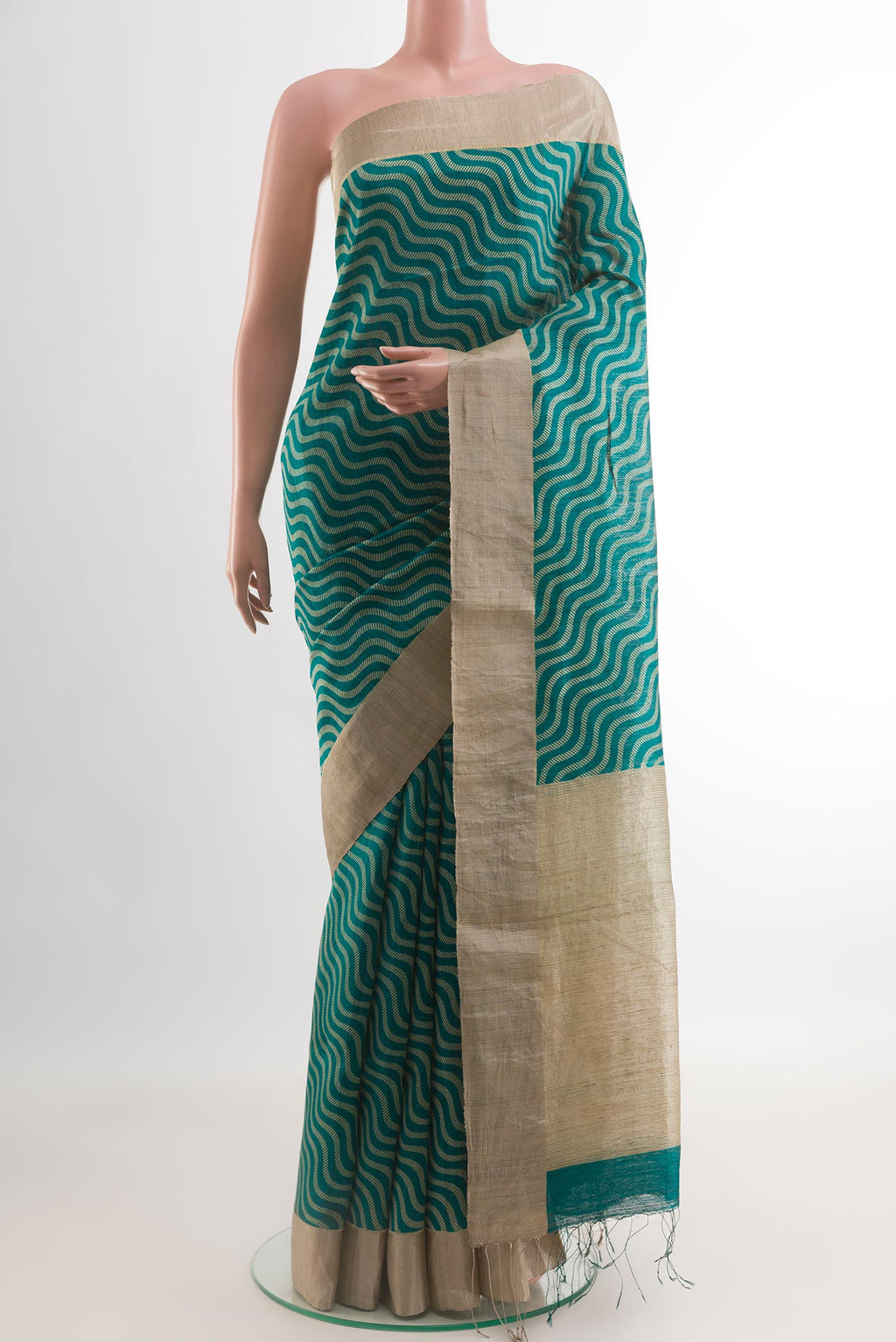 Sea Green Tussar Silk Saree with Printed design on the body and Zari Border.  displayed on a mannequin