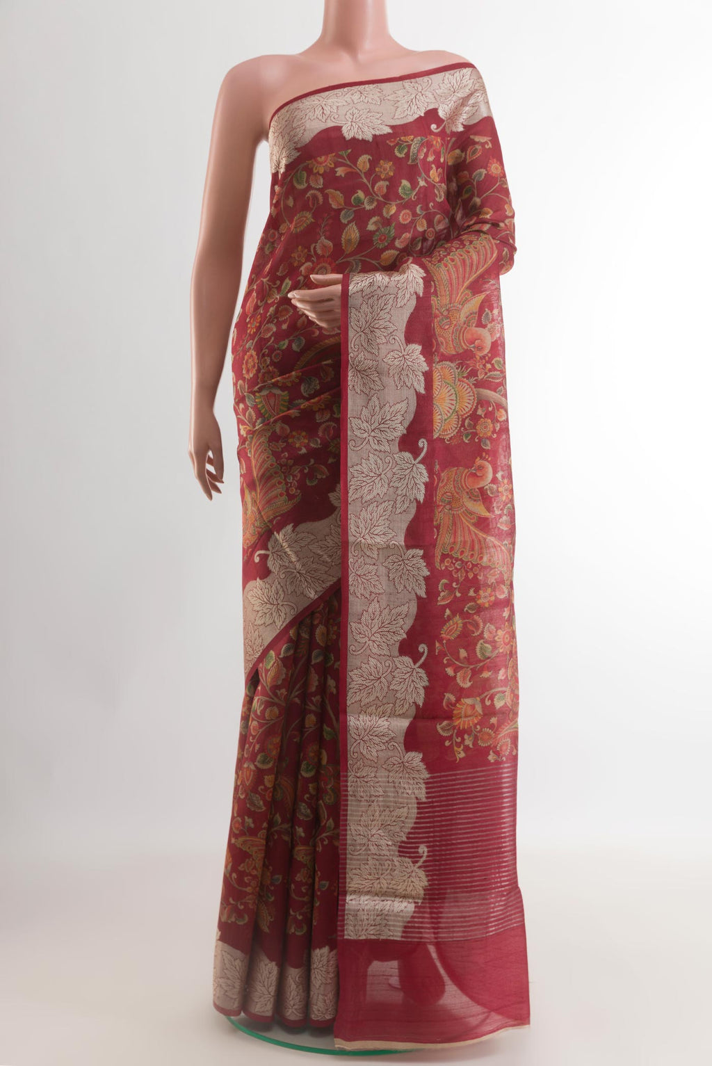 Maroon Tussar Silk Saree with Printed design on the body and Zari Border.  displayed on a mannequin
