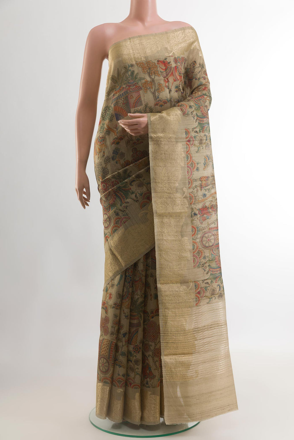 Beige Tussar Silk Saree with Printed design on the body and Zari Border.  displayed on a mannequin