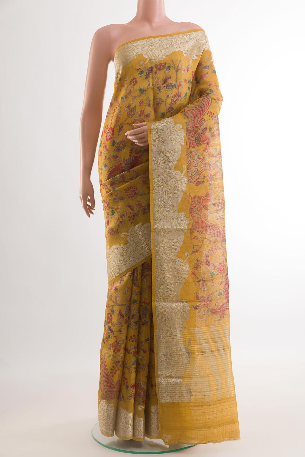 Mustard Tussar Silk Saree with Printed design on the body and Zari Border.  displayed on a mannequin
