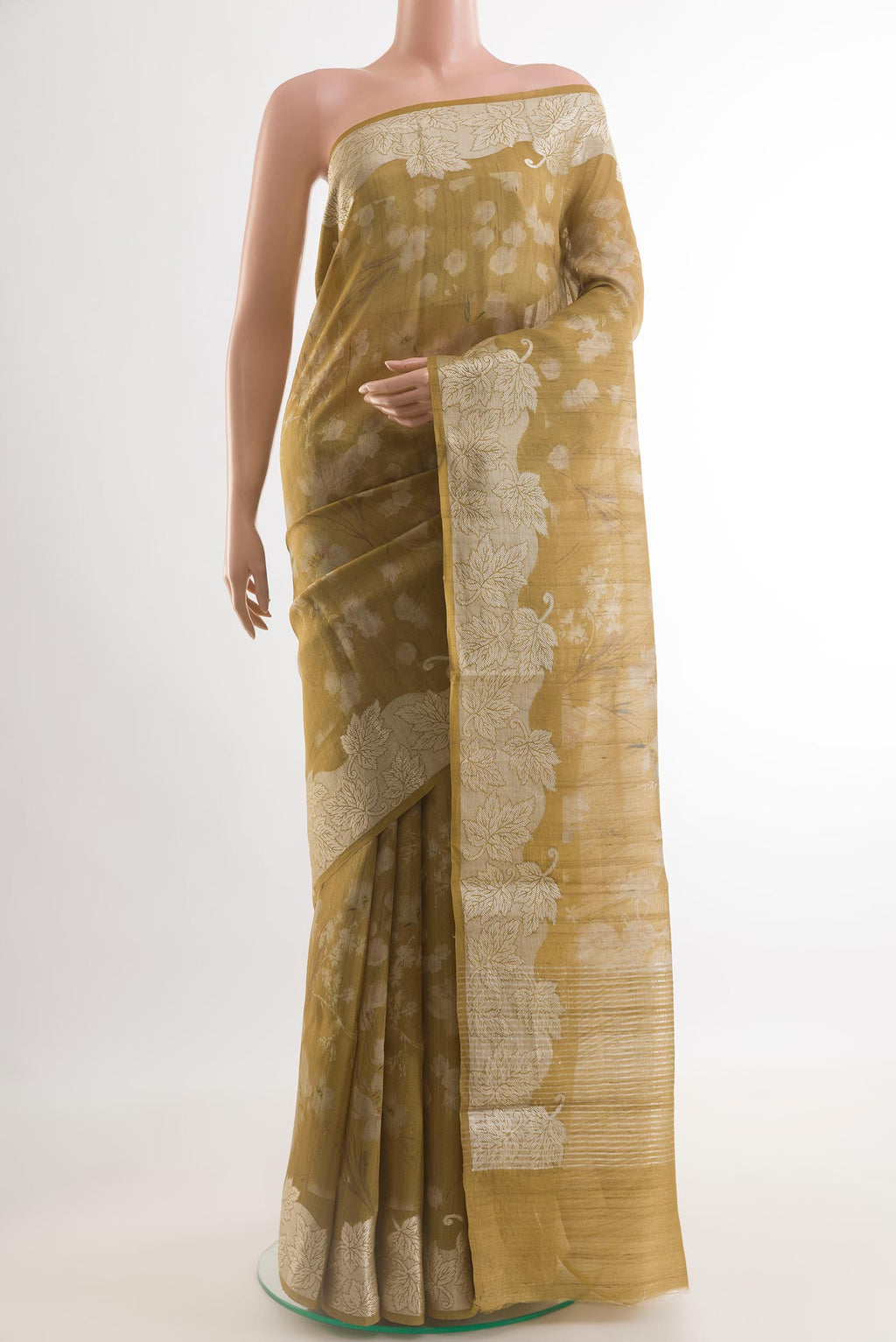 Mustard Tussar Saree with Printed design on the body and Zari Border.  displayed on a mannequin