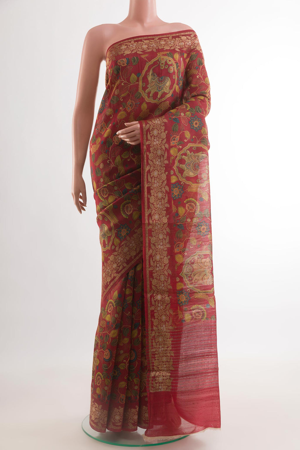 Red Tussar Silk Saree with Printed design on the body and Printed Border.  displayed on a mannequin