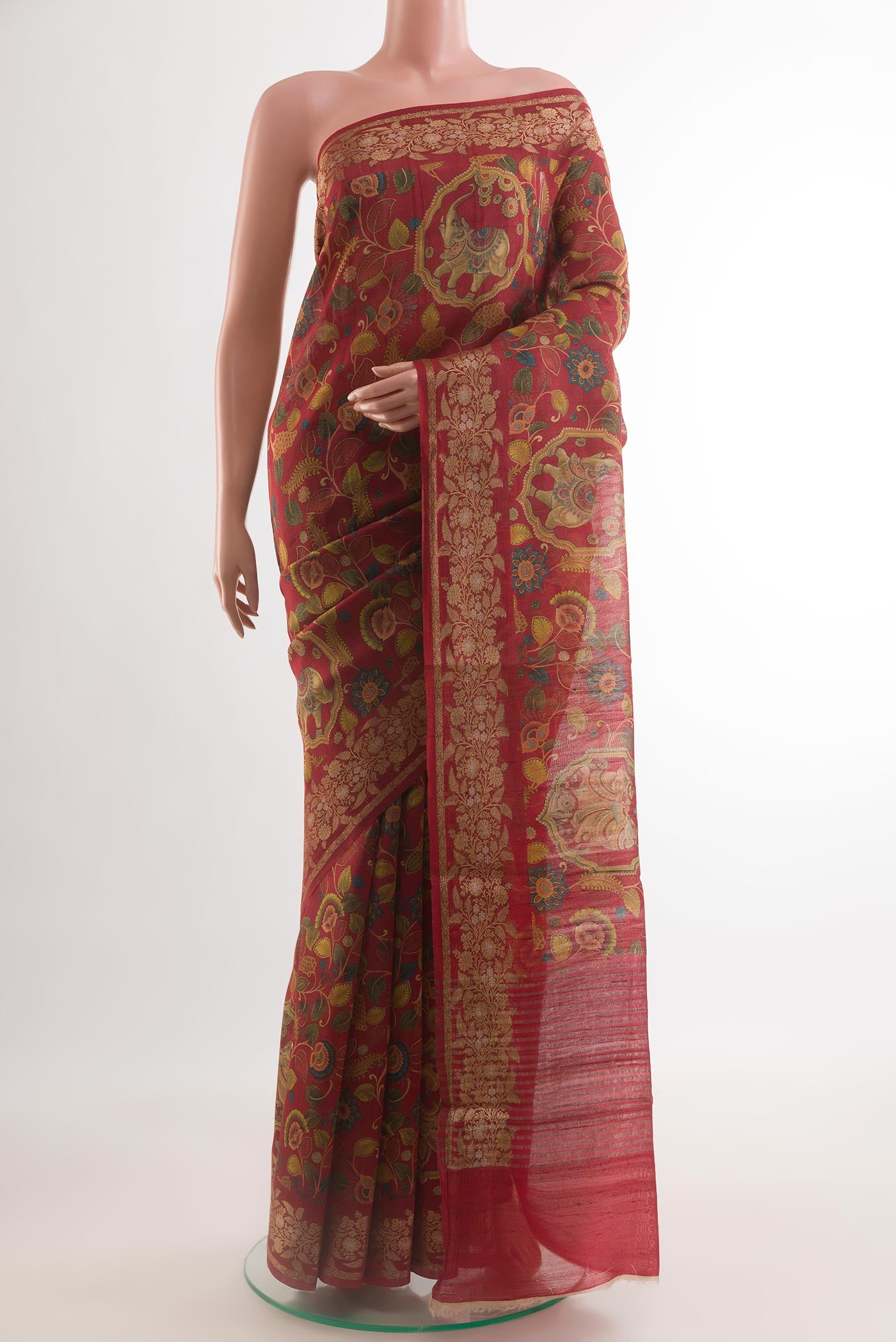 Red Tussar Silk Saree with Printed design on the body and Printed Border.  displayed on a mannequin