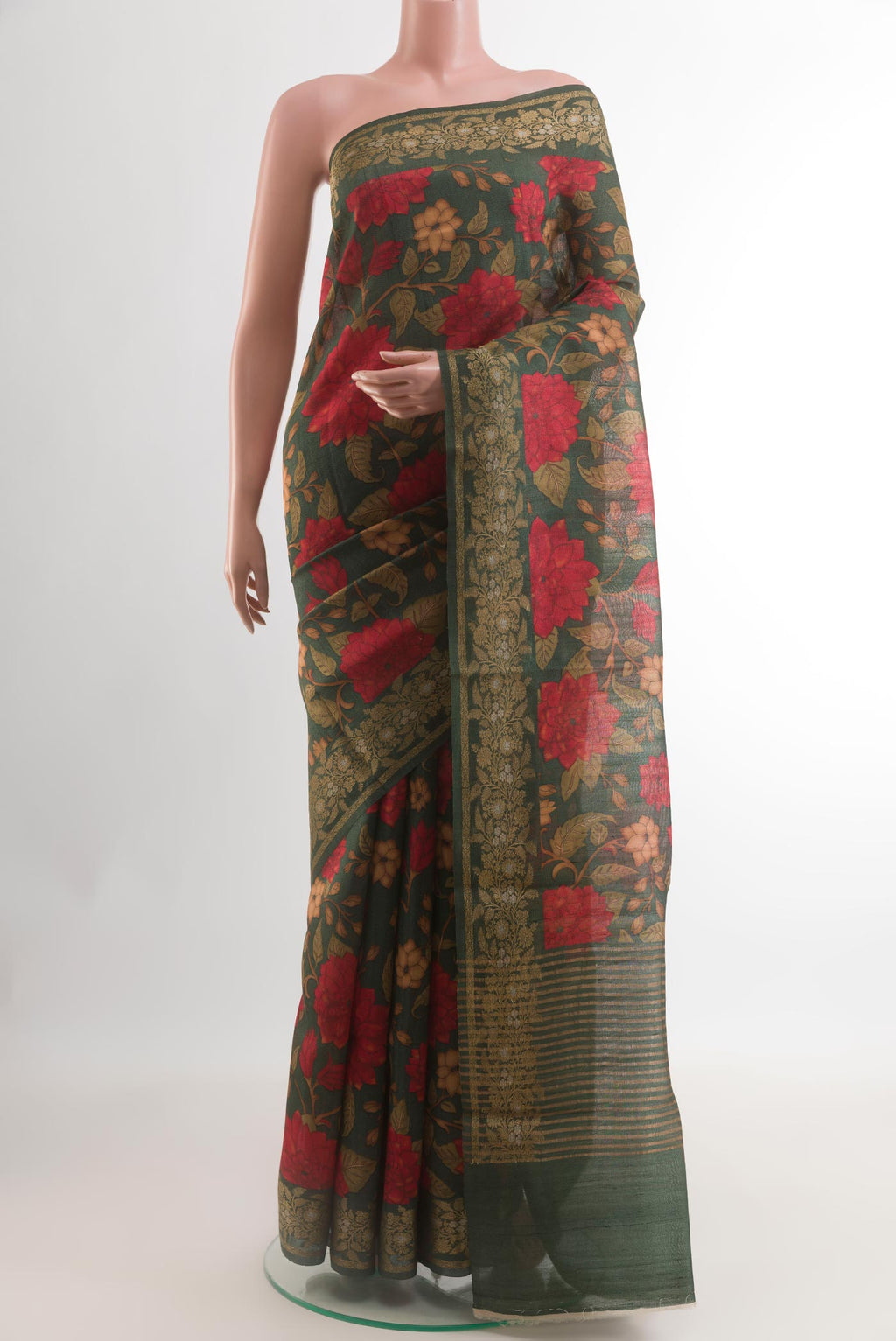 Bottle Green Tussar Silk Saree with Floral Print on the body and Zari Border.  displayed on a mannequin