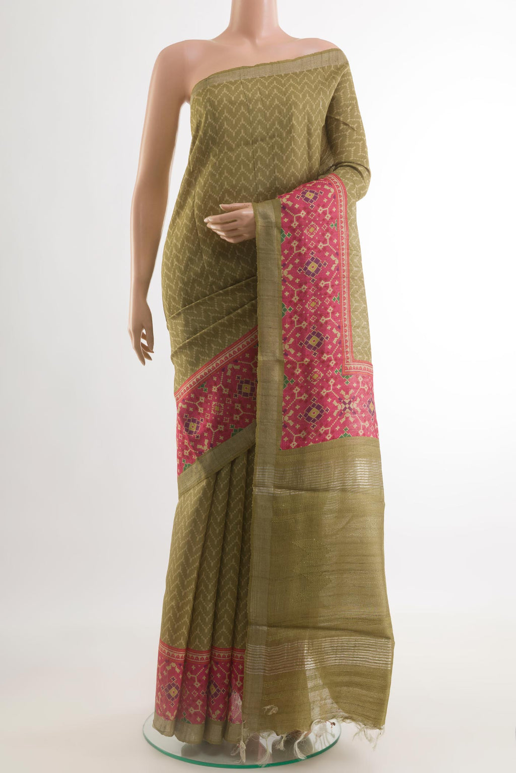 Mehandi Green Tussar Silk Saree with Printed design on the body and Printed Border.  displayed on a mannequin