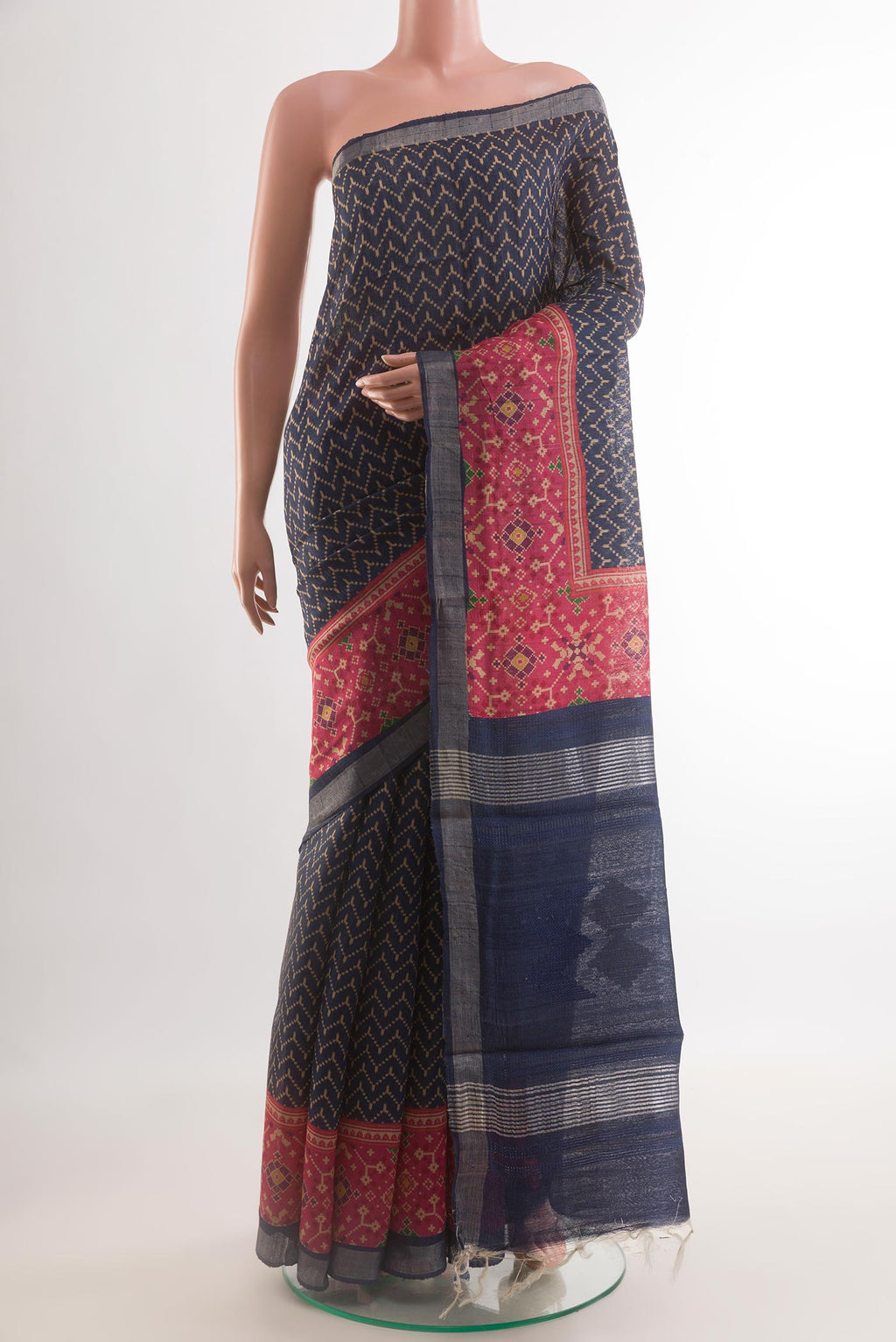 Navy Blue Tussar Silk Saree with Printed design on the body and Printed Border.  displayed on a mannequin