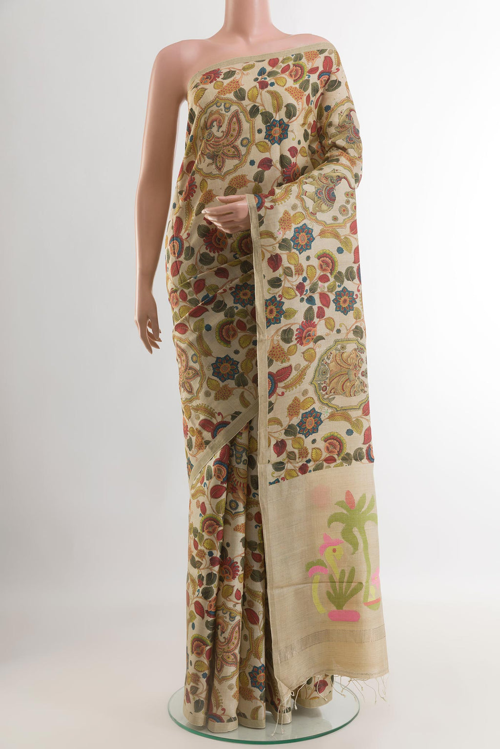 Cream Tussar Silk Saree with Printed design on the body and Zari Border.  displayed on a mannequin