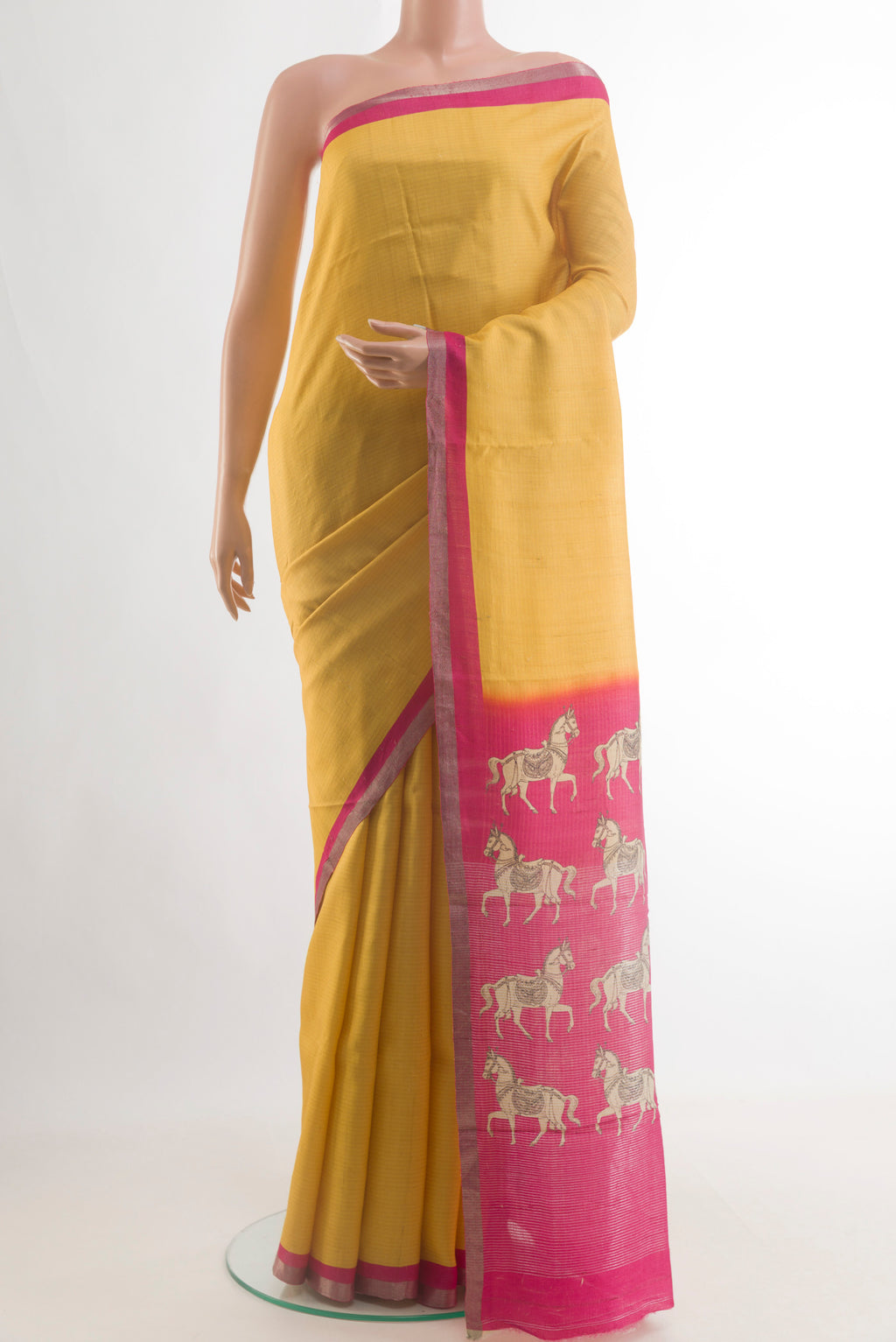 Yellow Tussar Saree with Zari Butta on the body and Zari Border.  displayed on a mannequin