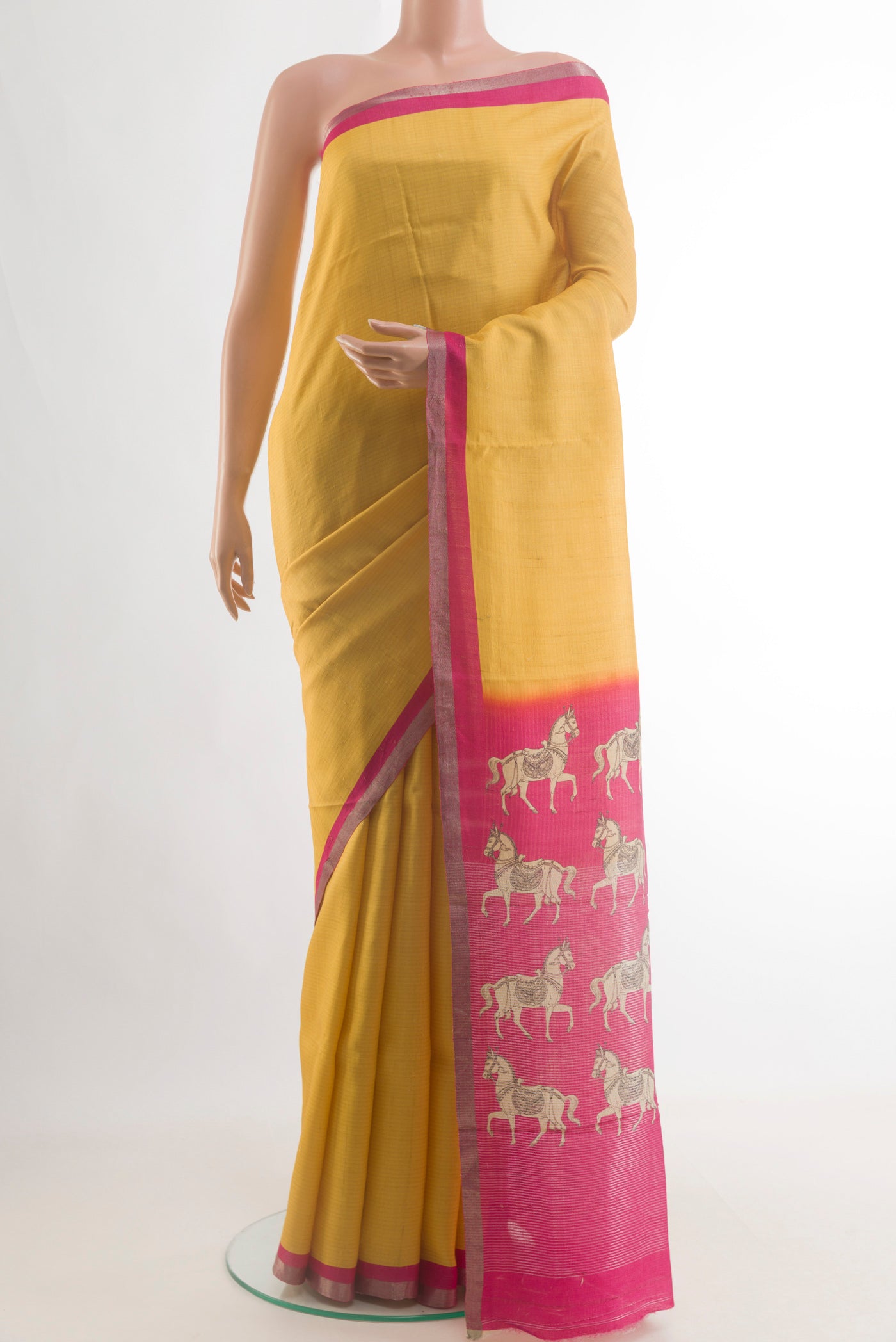 Yellow Tussar Saree with Zari Butta on the body and Zari Border.  displayed on a mannequin