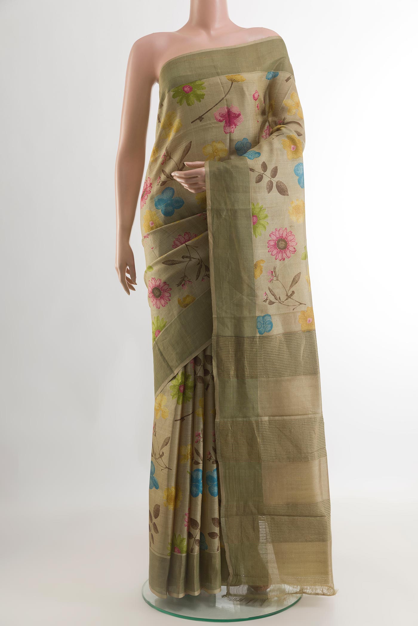 Beige Tussar Silk Saree with Printed design on the body and Zari Border.  displayed on a mannequin