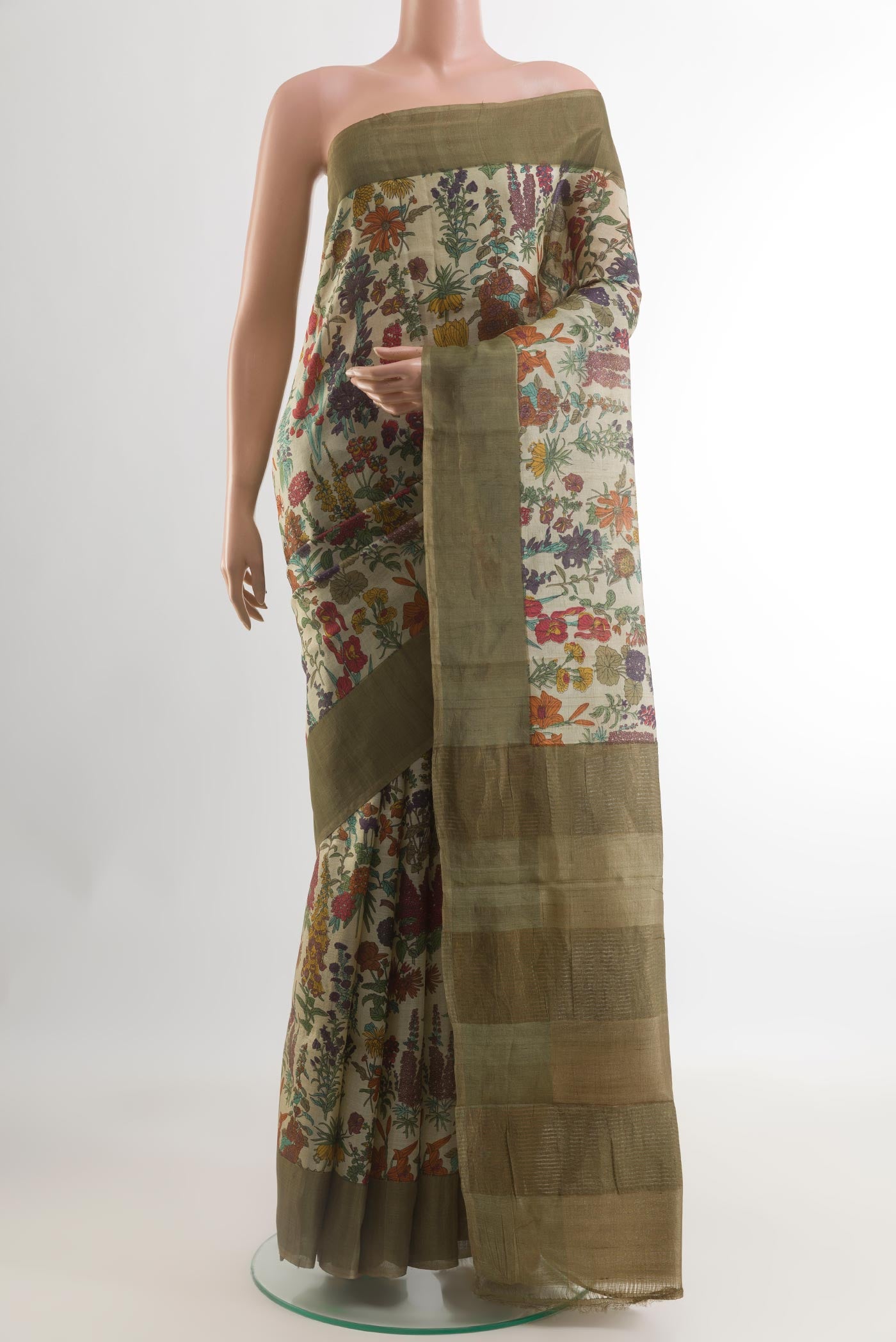Beige Tussar Silk Saree with Printed design on the body and Zari Border.  displayed on a mannequin