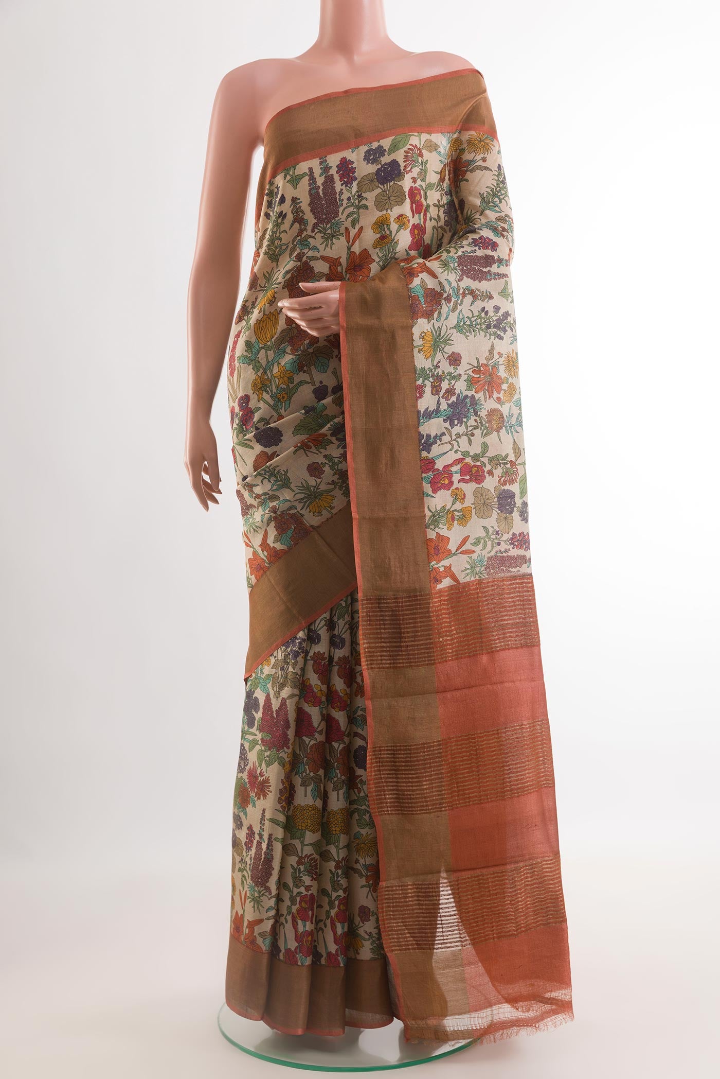 Beige Tussar Silk Saree with Printed design on the body and Zari Border.  displayed on a mannequin