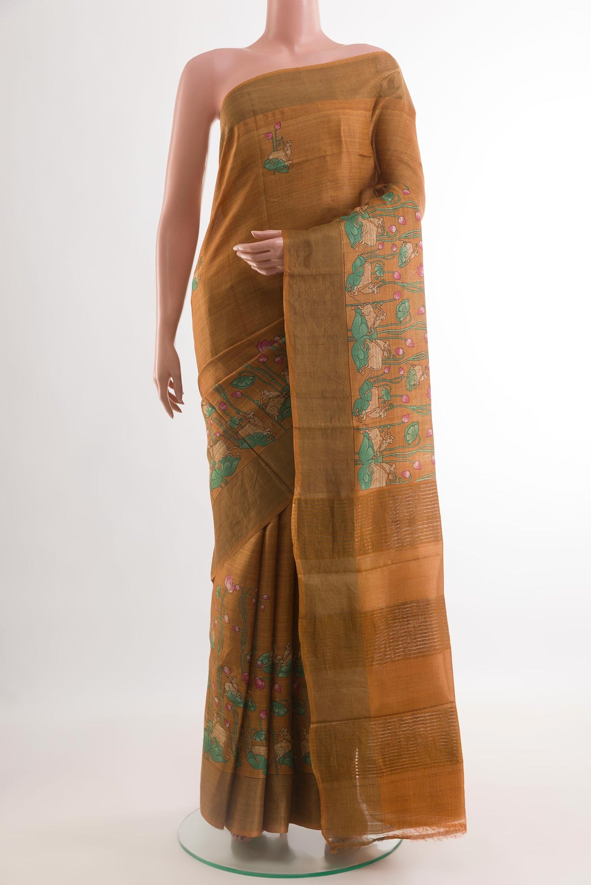 Brown Tussar Silk Saree with Printed design on the body and Zari Border.  displayed on a mannequin