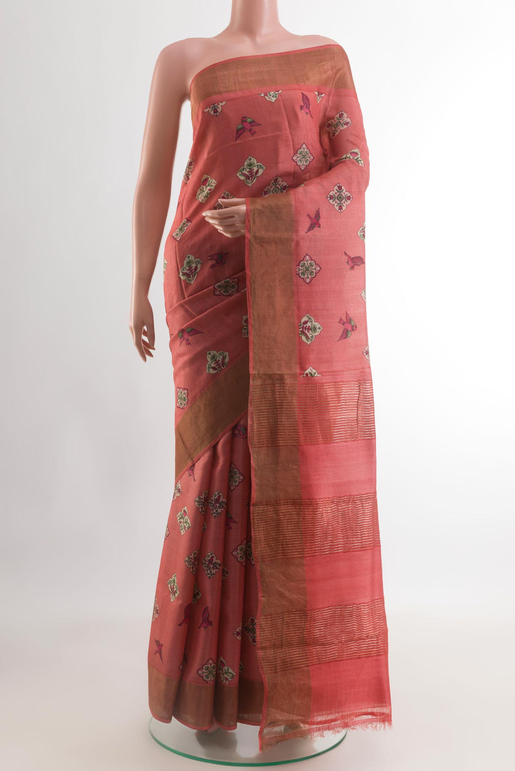 Red Tussar Silk Saree with Printed design on the body and Zari Border.  displayed on a mannequin