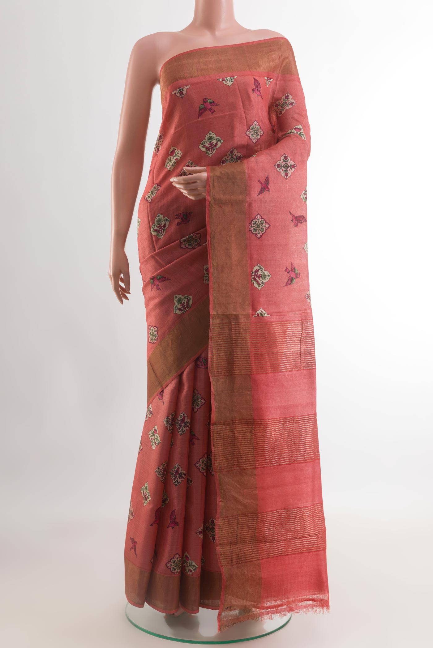 Red Tussar Silk Saree with Printed design on the body and Zari Border.  displayed on a mannequin