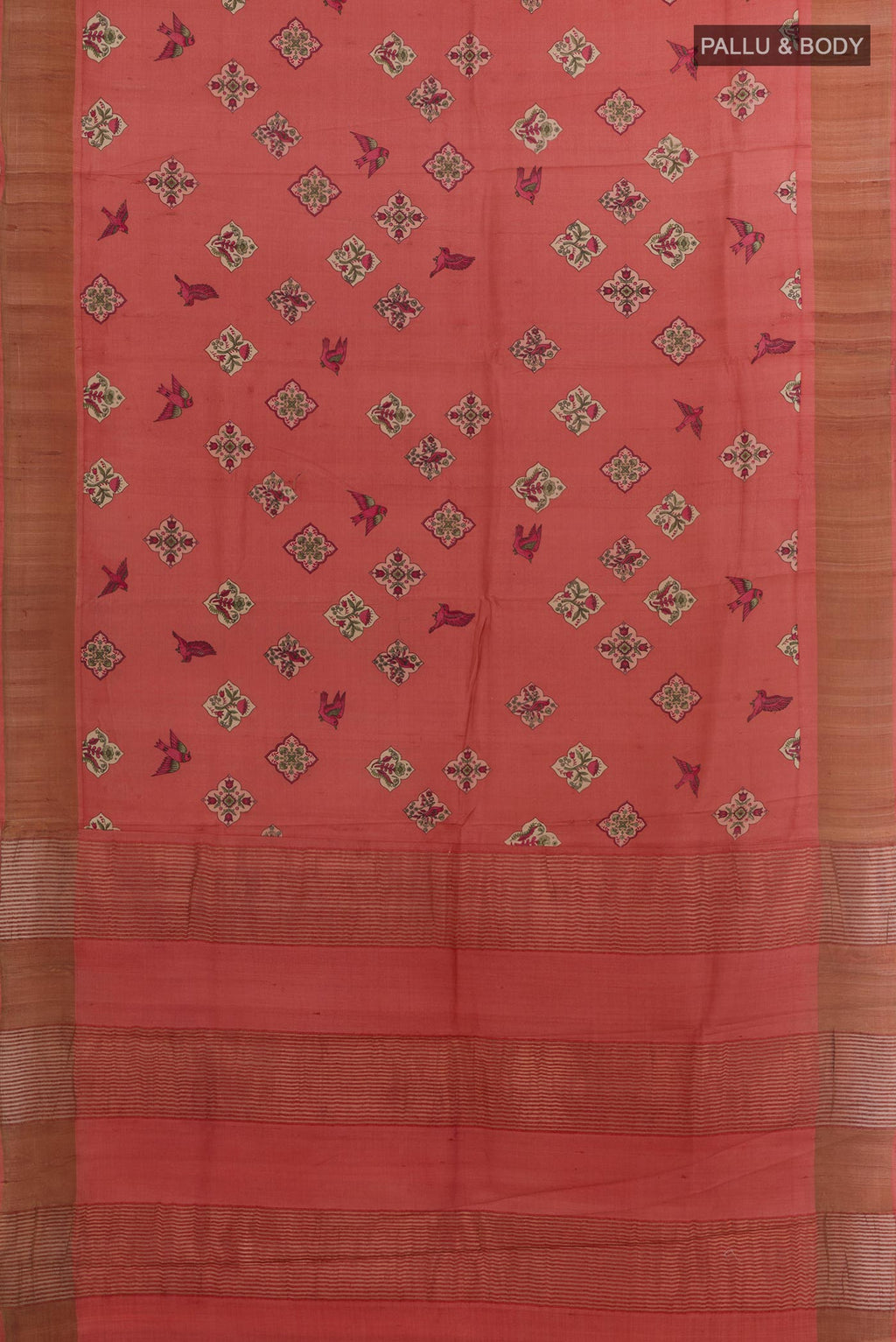 Flat view of Red Tussar Silk Saree with Printed design on the body and Zari Border. 