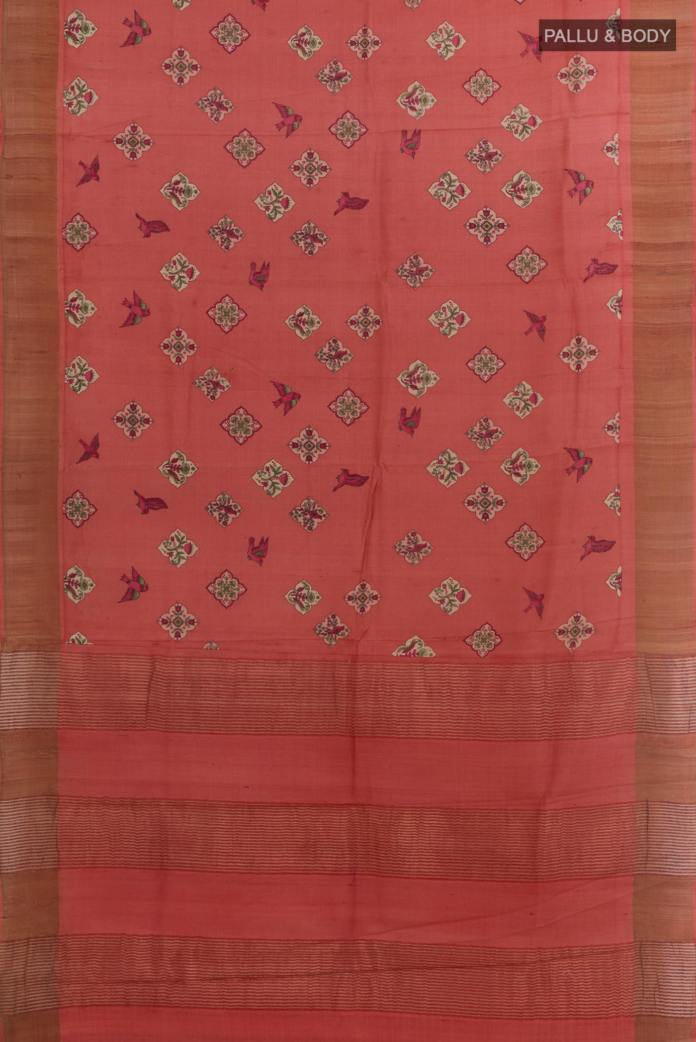 Flat view of Red Tussar Silk Saree with Printed design on the body and Zari Border. 