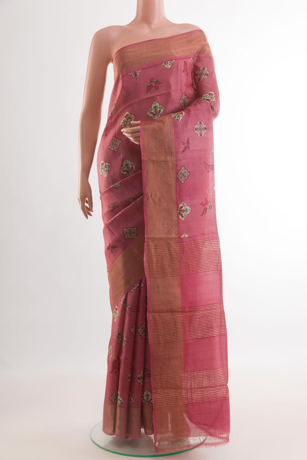 Pink Tussar Silk Saree with Printed design on the body and Zari Border.  displayed on a mannequin