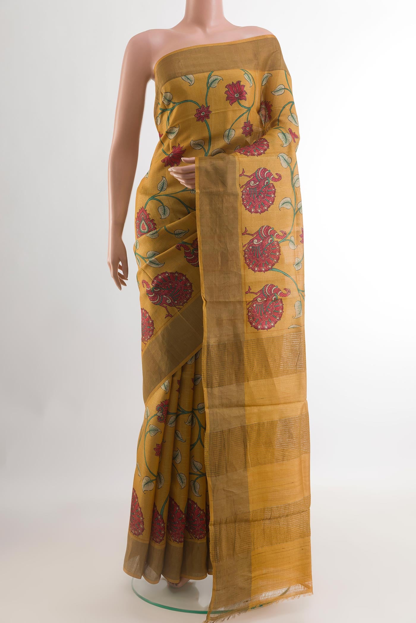 Yellow Tussar Silk Saree with Printed design on the body and Zari Border.  displayed on a mannequin