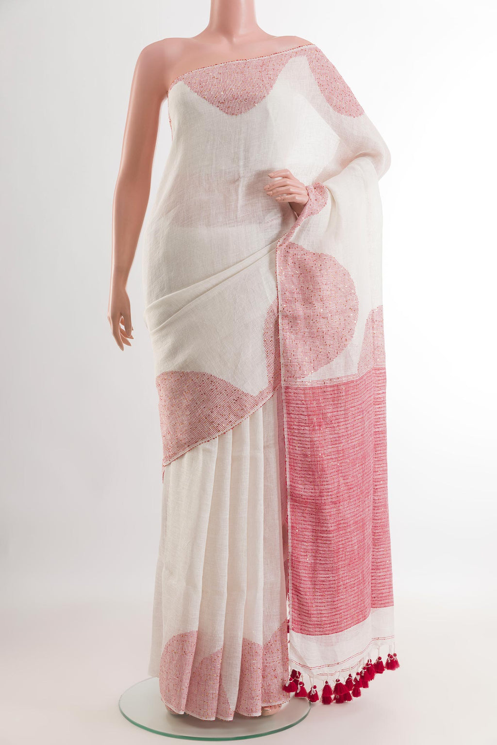 White Linen Saree with Embroidery on the body and Embroidery Border.  displayed on a mannequin