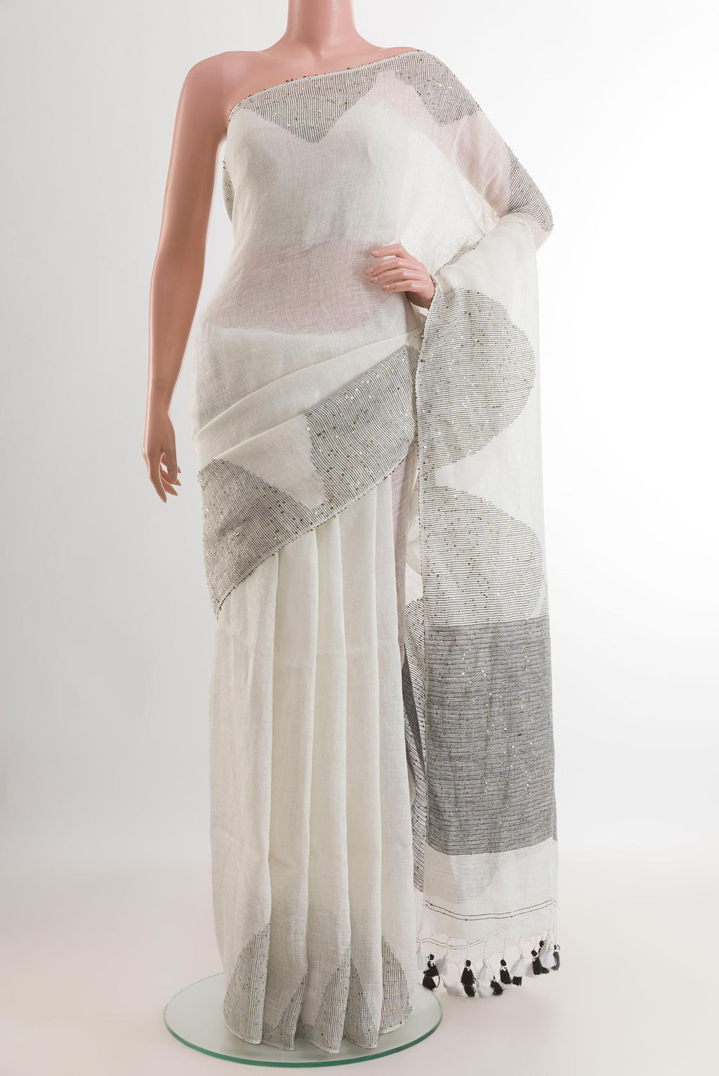 White Linen Saree with Embroidery on the body and Embroidery Border.  displayed on a mannequin