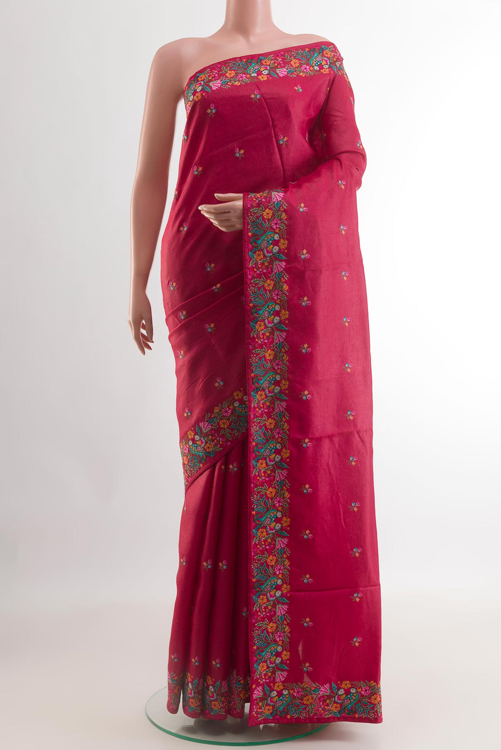 Red Tussar Silk Saree with Embroidery on the body and Embroidery Border.  displayed on a mannequin