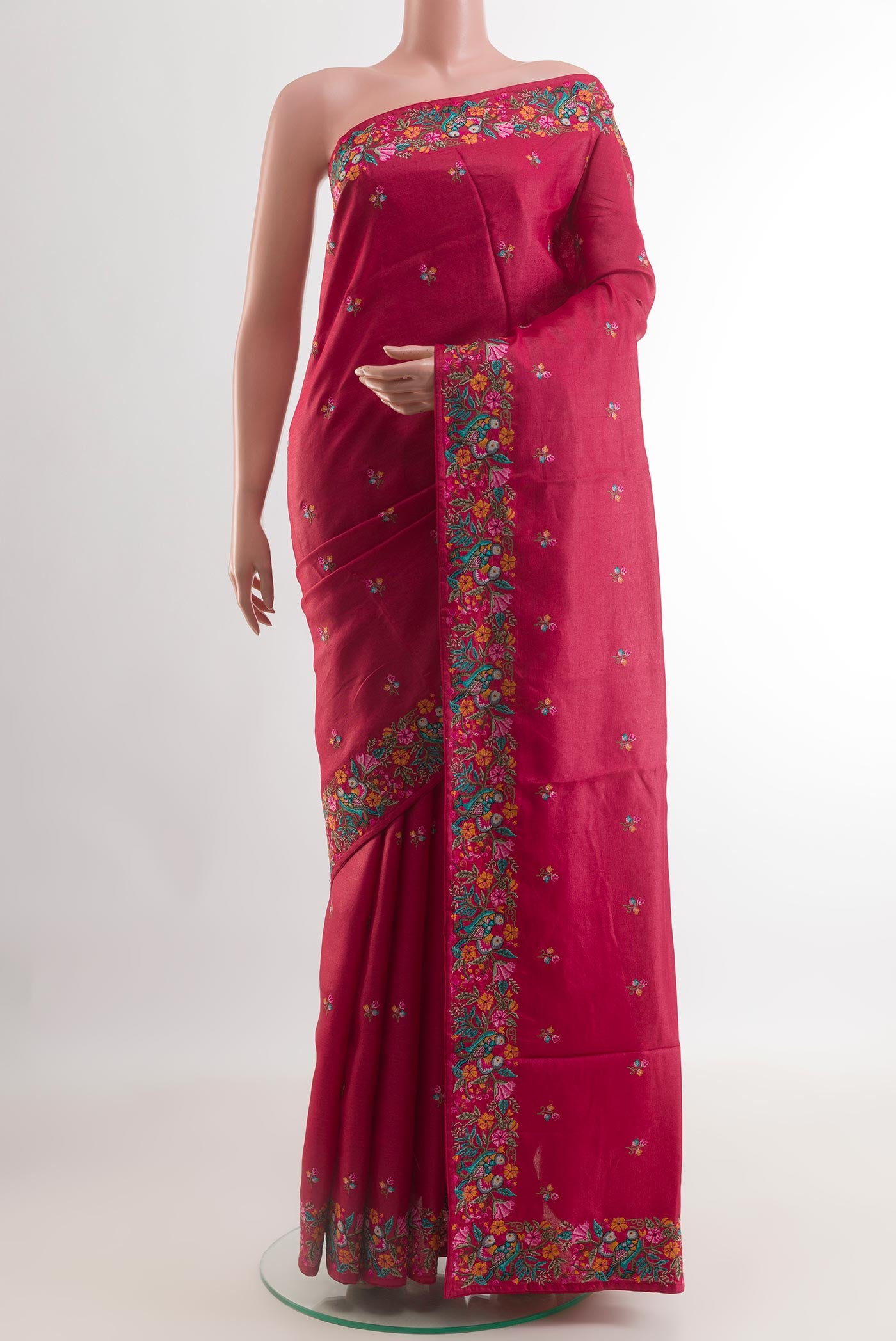Red Tussar Silk Saree with Embroidery on the body and Embroidery Border.  displayed on a mannequin