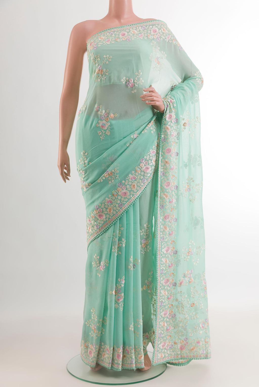 Sea Green Georgette Saree with Embroidery on the body and Embroidery Border.  displayed on a mannequin