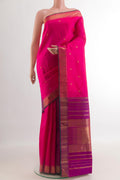 Pink Kanchipuram Silk Saree with Zari Butta on the body and Zari Border.  displayed on a mannequin