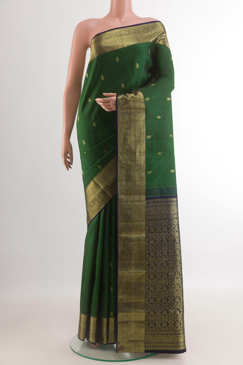Bottle Green Kanchipuram Silk Saree with Zari Butta on the body and Zari Border.  displayed on a mannequin