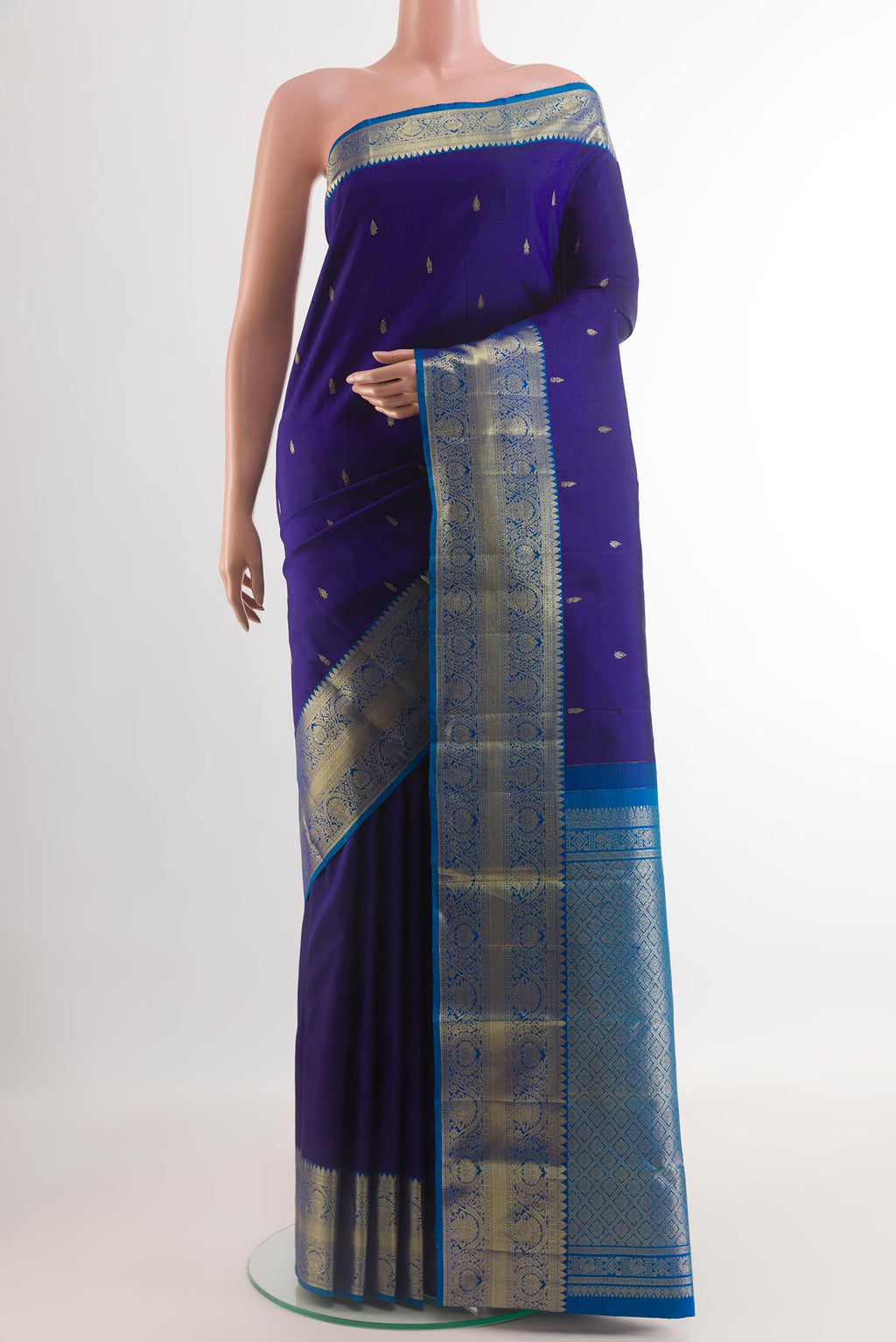 Dark Blue Kanchipuram Silk Saree with Zari Butta on the body and Zari Border.  displayed on a mannequin