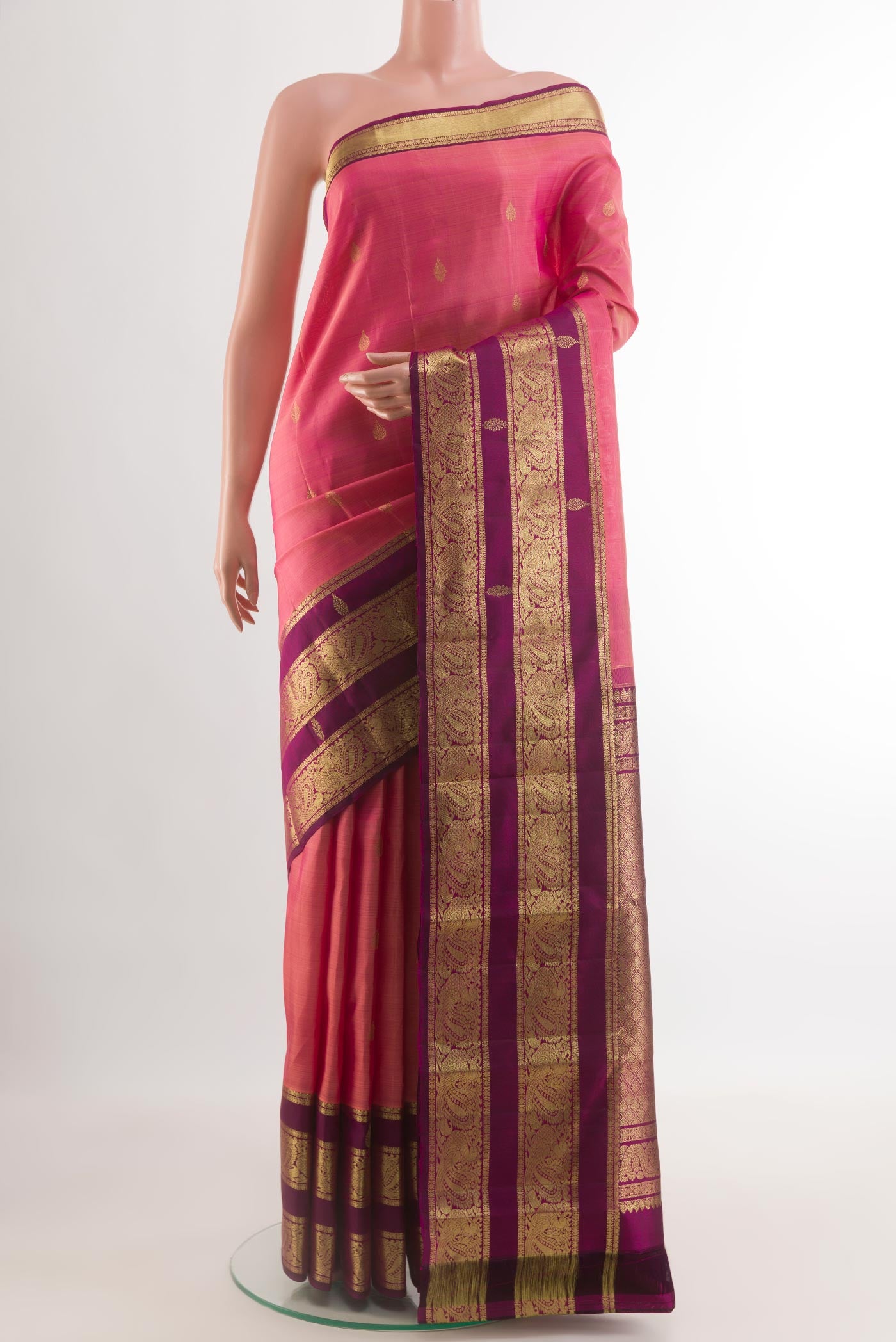Pink Kanchipuram Silk Saree with Zari Butta on the body and Zari Border.  displayed on a mannequin