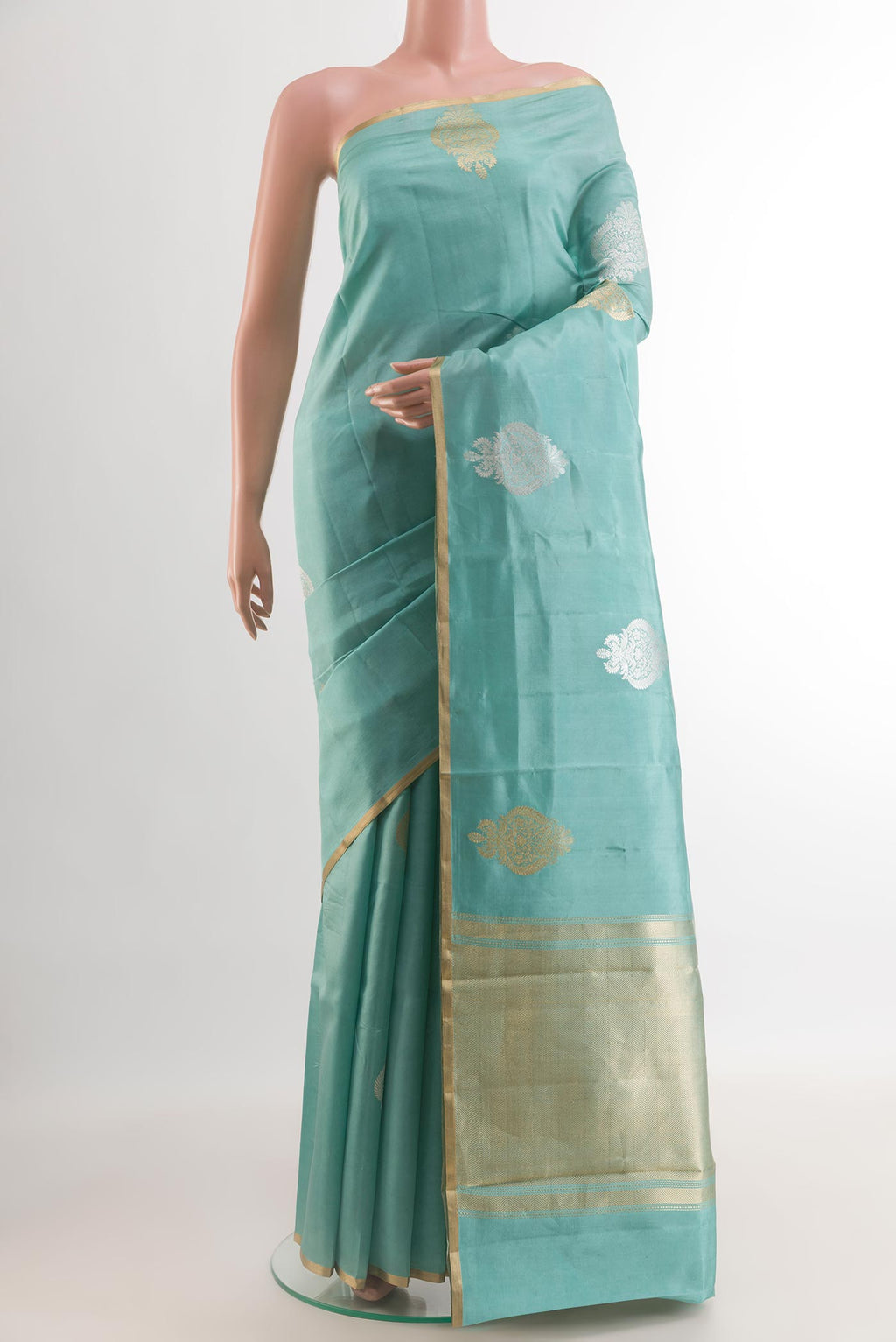 Blue Banarasi Katan Silk Saree with Zari Butta on the body and Zari Border.  displayed on a mannequin