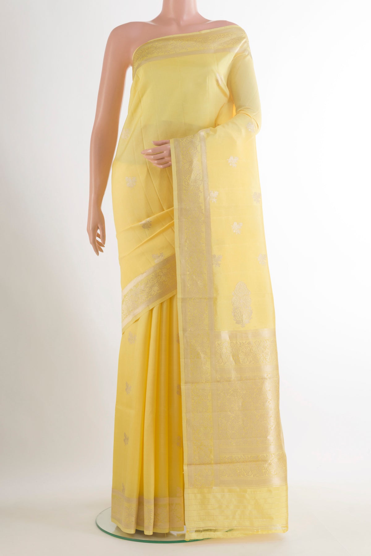Pure Silk Yellow Banarasi Katan Saree with Zari Butta on the body and Zari Border.  displayed on a mannequin