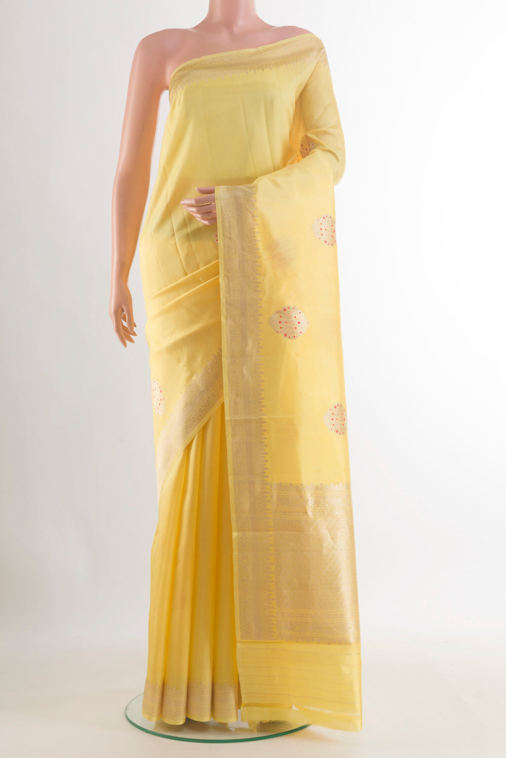 Pure Silk Yellow Banarasi Katan Saree with Zari Butta on the body and Zari Border.  displayed on a mannequin