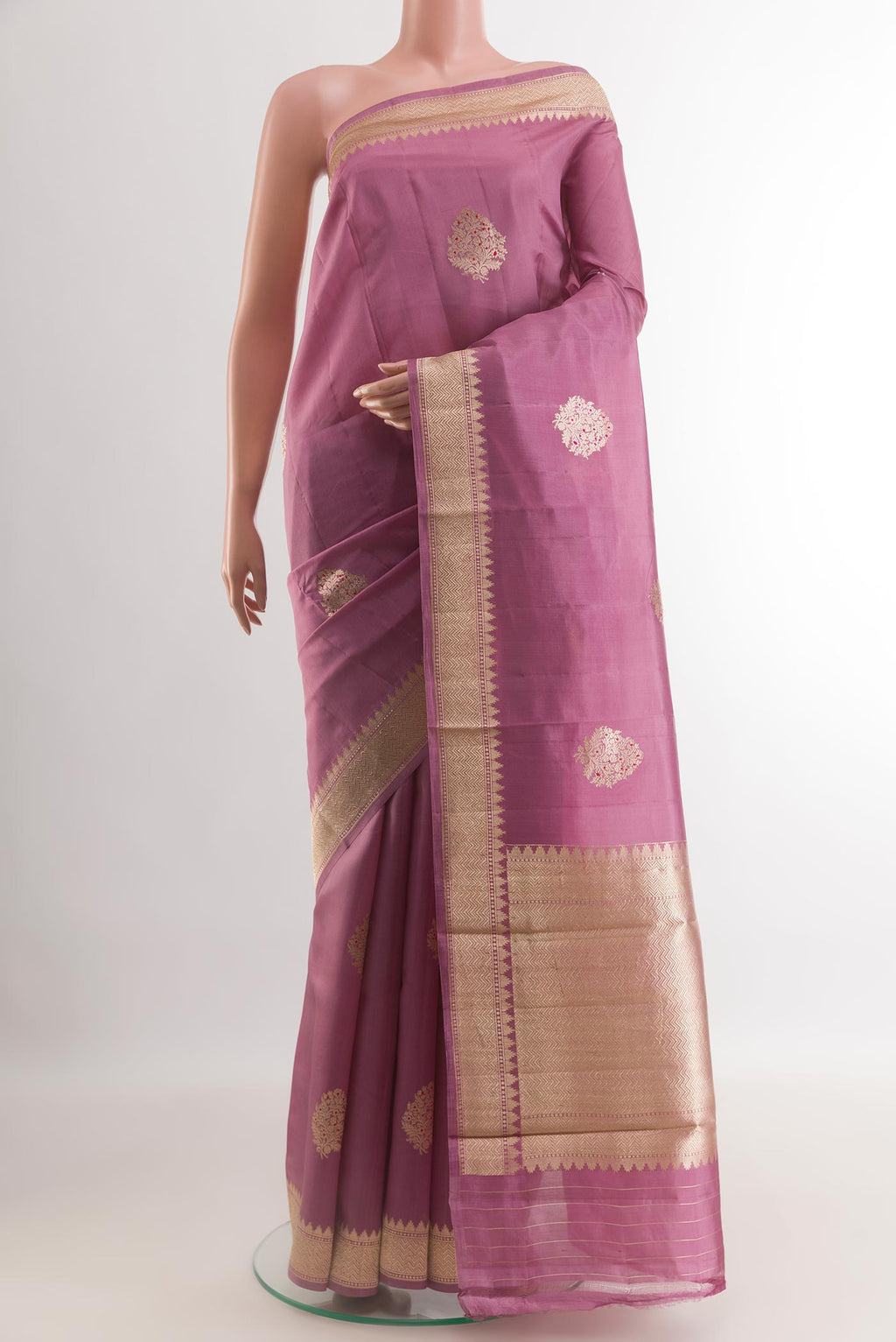 Lavender Banarasi Katan Silk Saree with Zari Butta on the body and Zari Border.  displayed on a mannequin