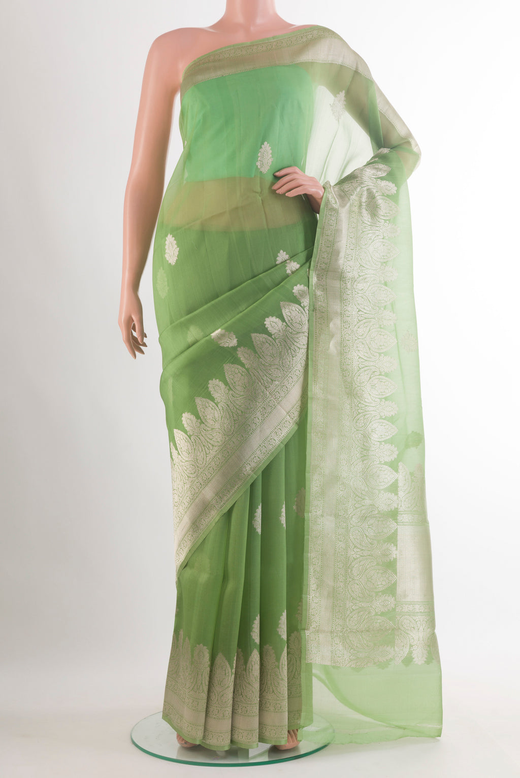 Pista Green Organza Saree with Zari Butta on the body and Zari Border.  displayed on a mannequin